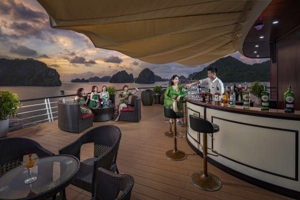 Guests at the Aspira Cruise deck bar at sunset