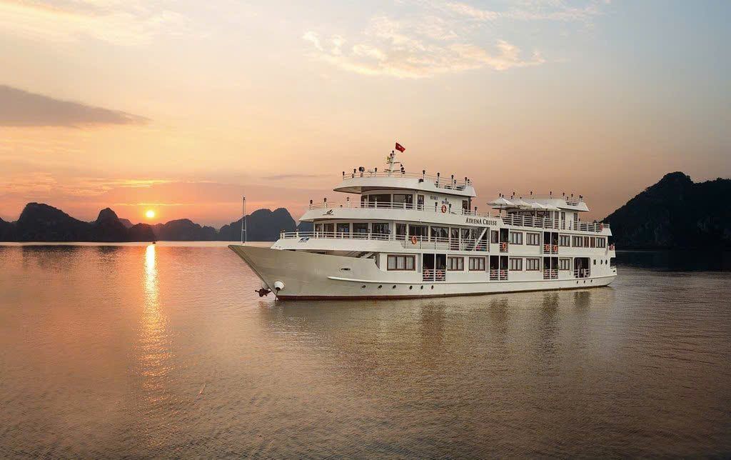 Athena Luxury Cruise at sunset among the karsts of Ha Long Bay