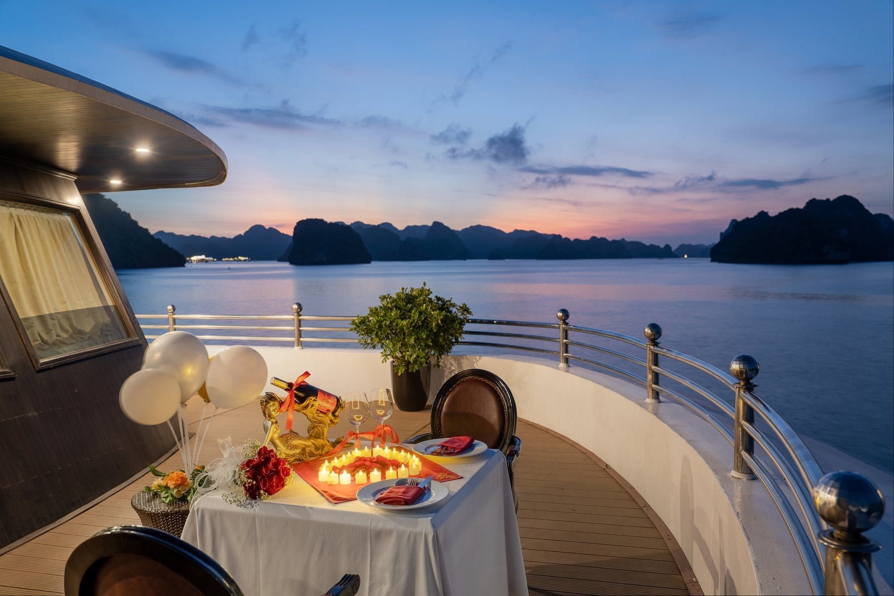 A private dinner laid for two on the Athena Luxury deck as the sun sets over the bay