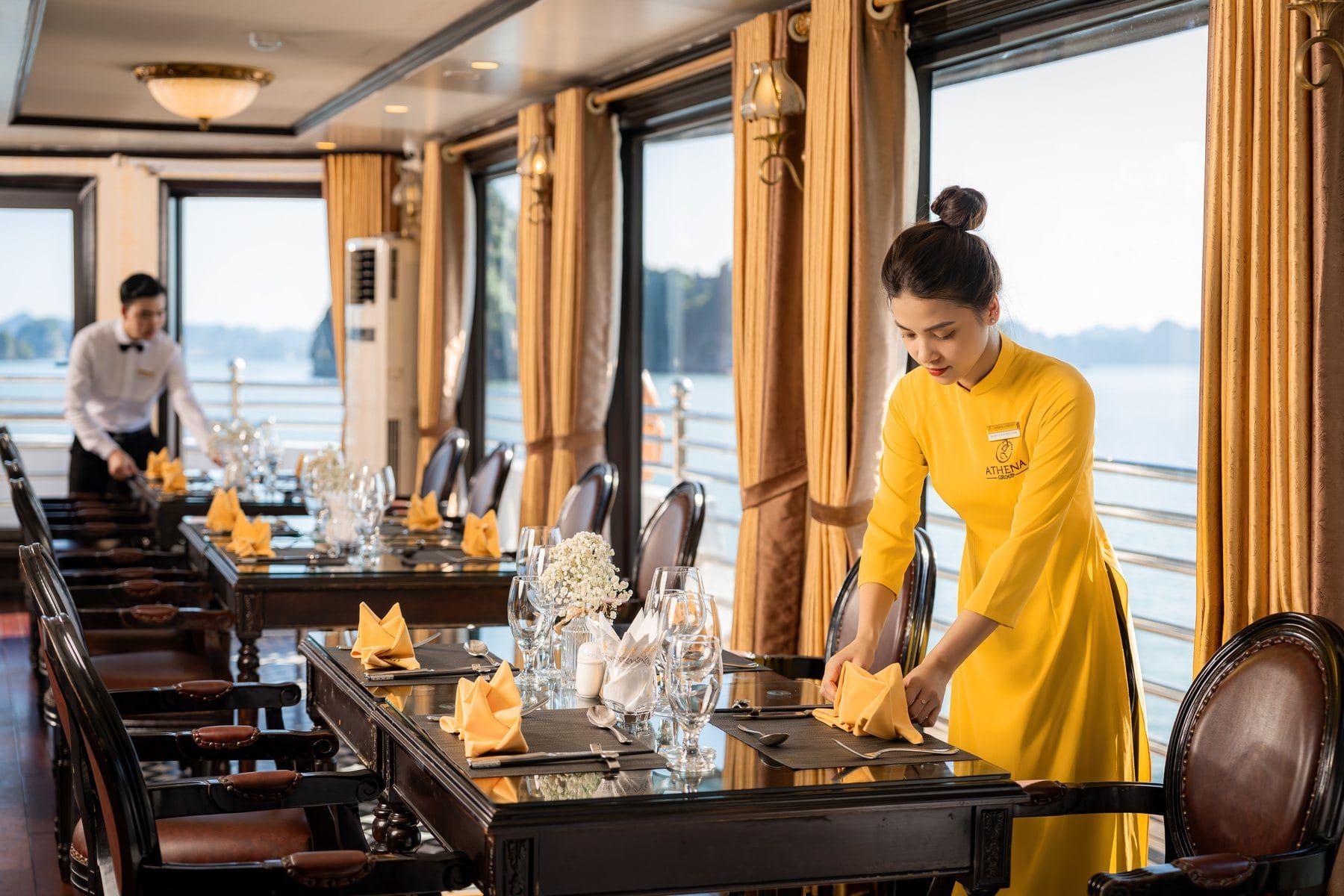 A table being laid in the Athena Luxury restaurant