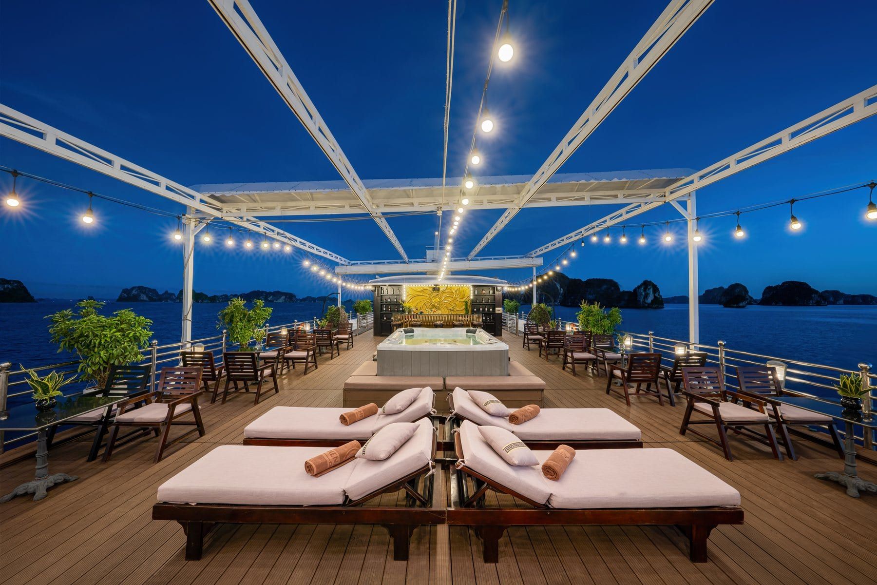 The Athena Luxury sundeck at dusk, loungers laid out beneath the canopy