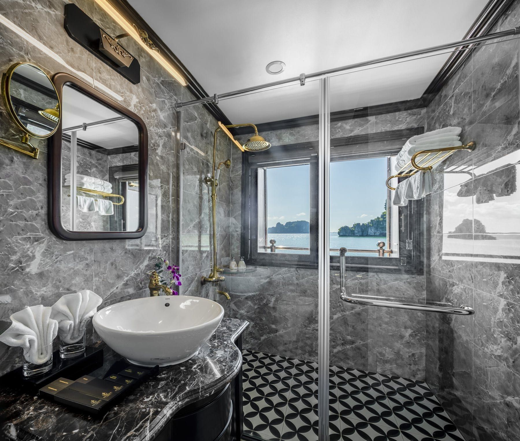 A Deluxe Suite bathroom, marble surround and monochrome tiled floor
