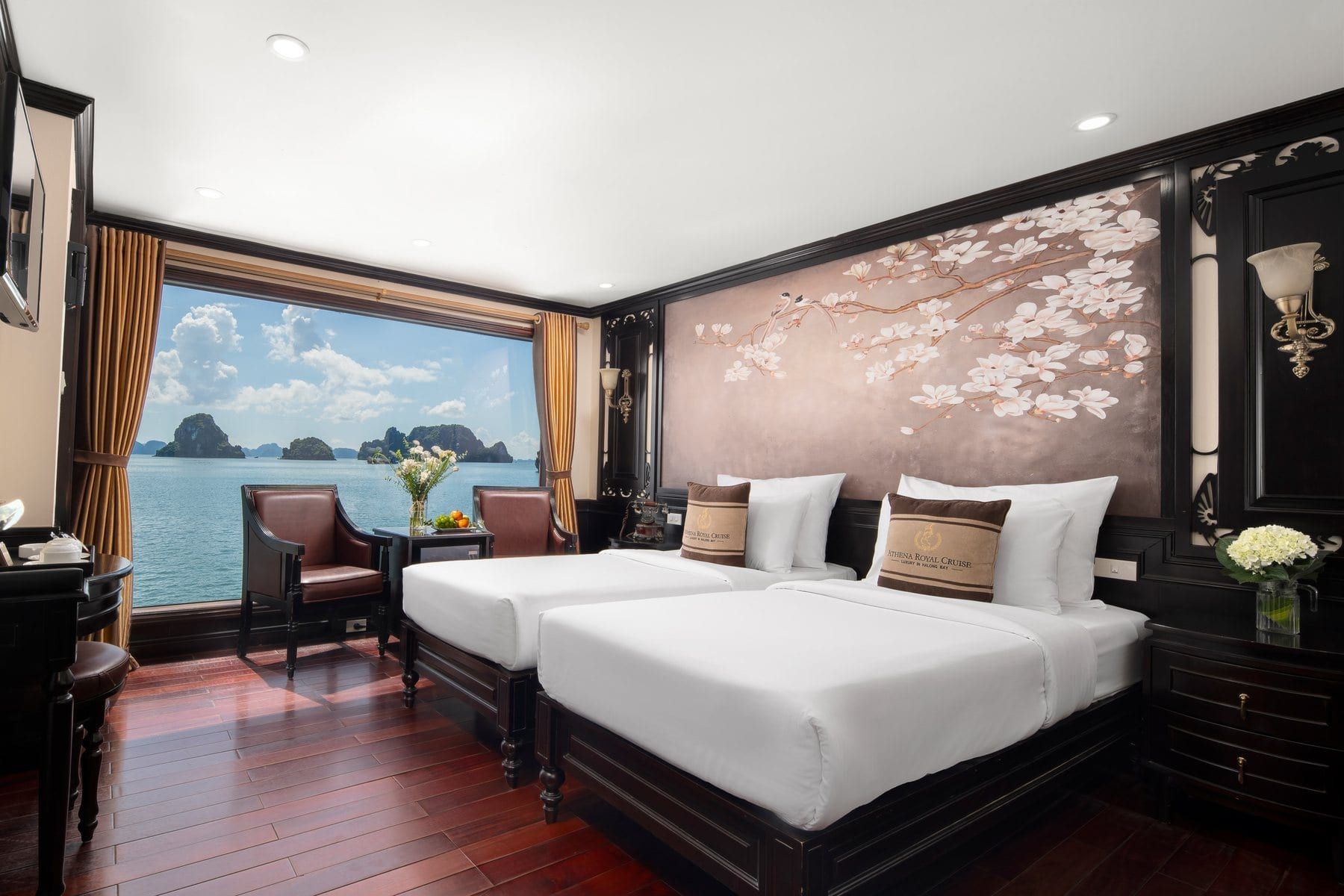 Twin beds in an Elegance Suite looking out over the water