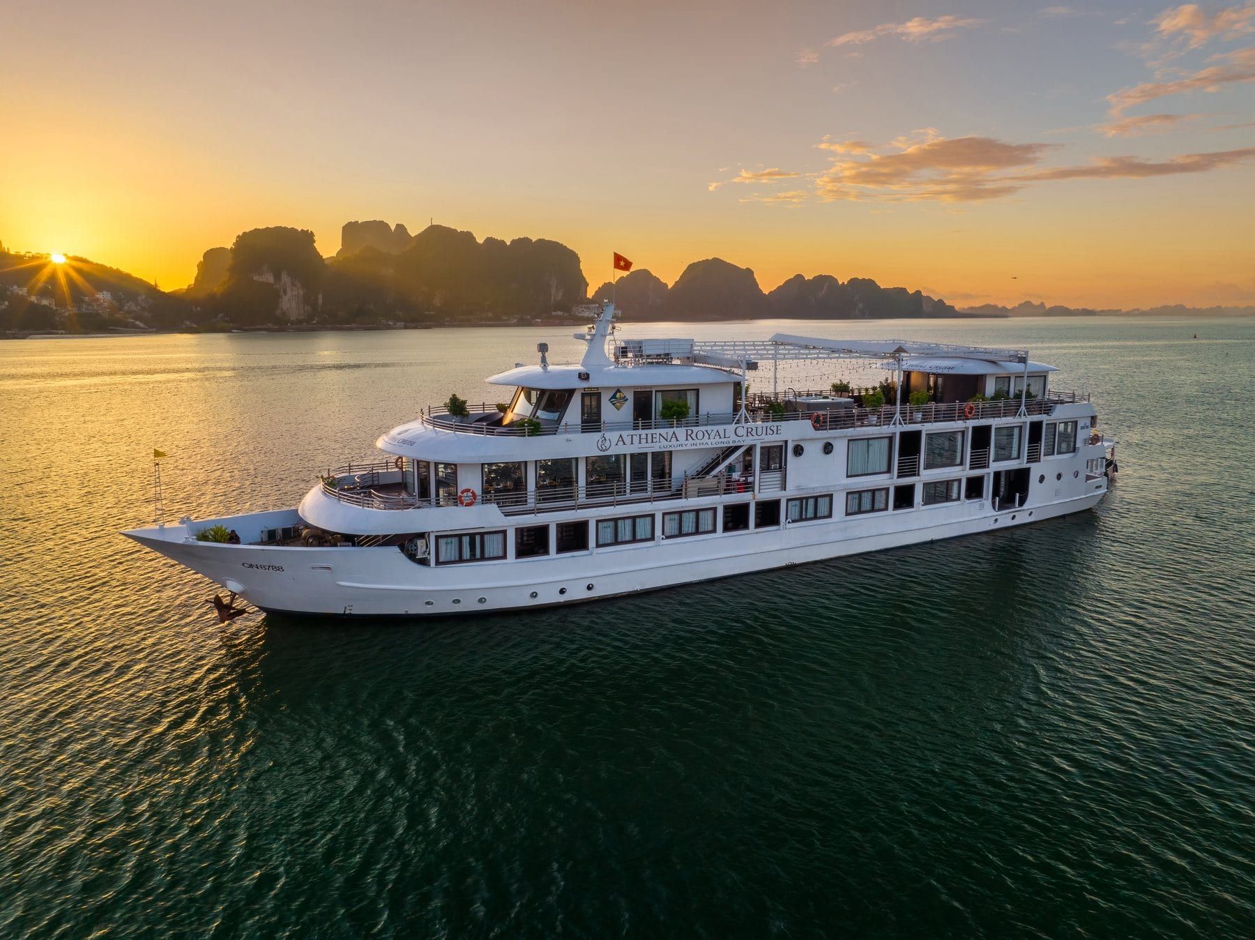 Athena Royal Cruise at sunset in Ha Long Bay