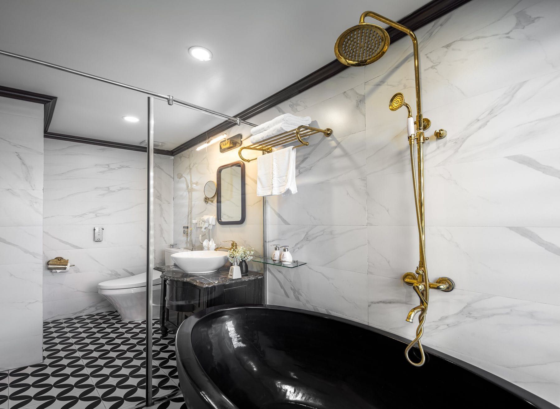 The Premium Terrace bathroom, brass shower fittings against white marble