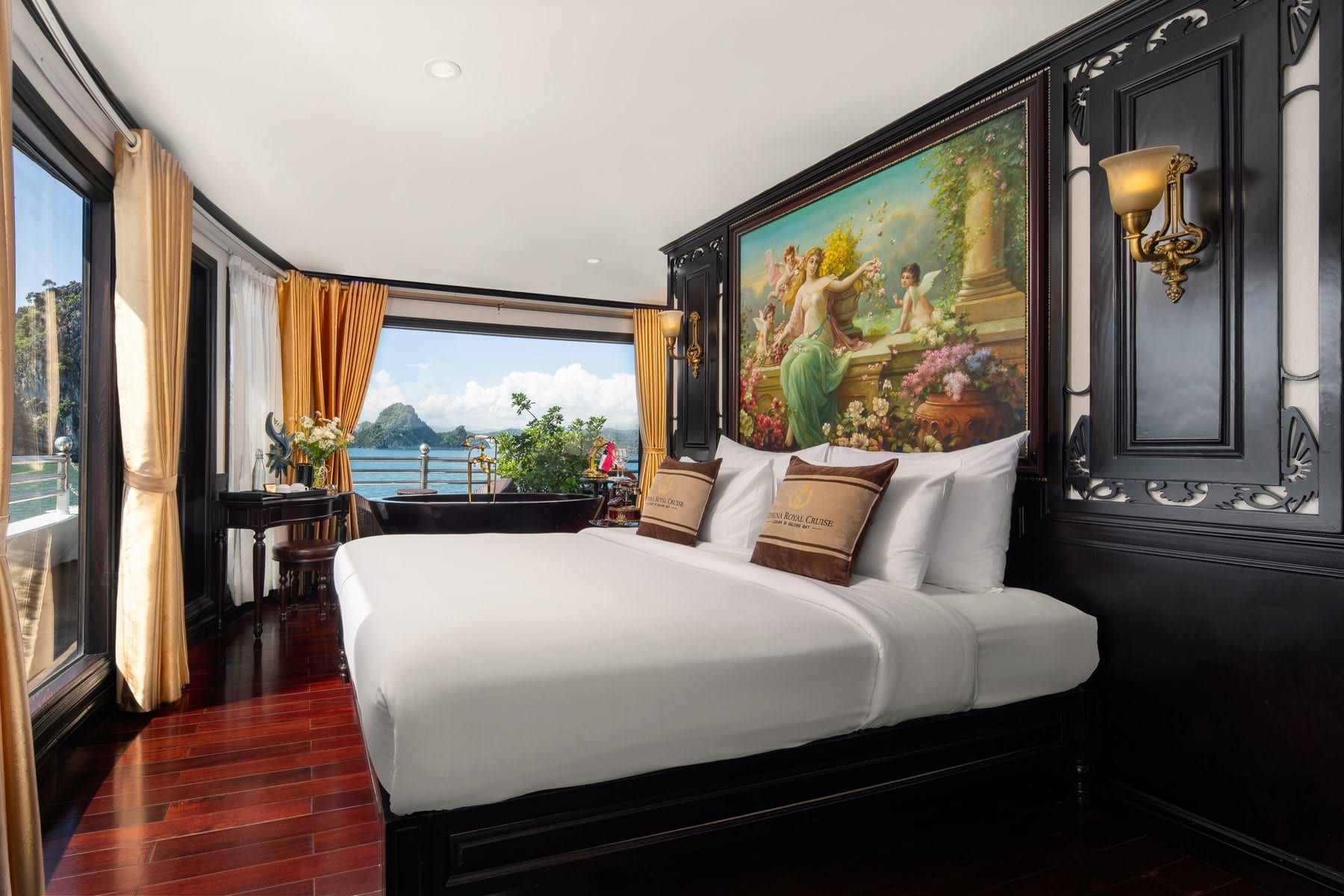 The Royal Suite aboard Athena Royal, painted mural above the bed and bay windows alongside
