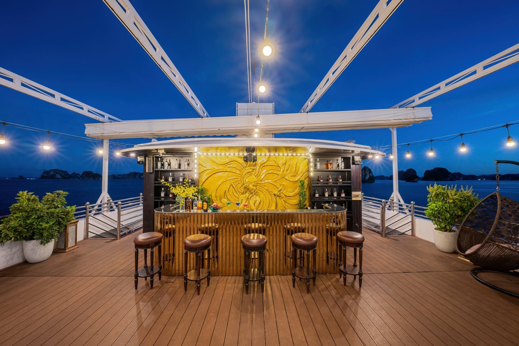 The sundeck bar under its canopy, stools facing the bay