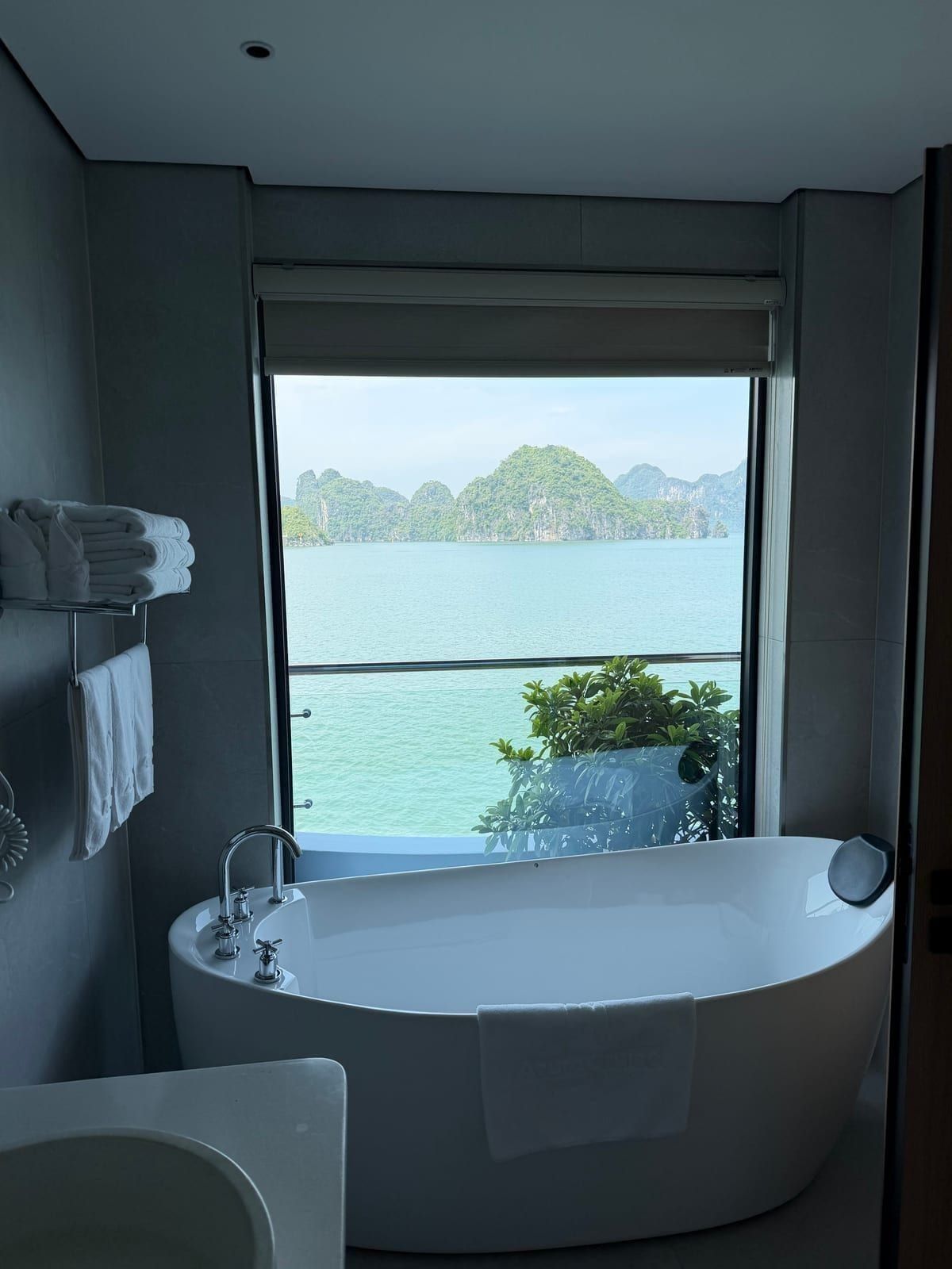 A freestanding bathtub facing the bay in an Azura Cruise suite