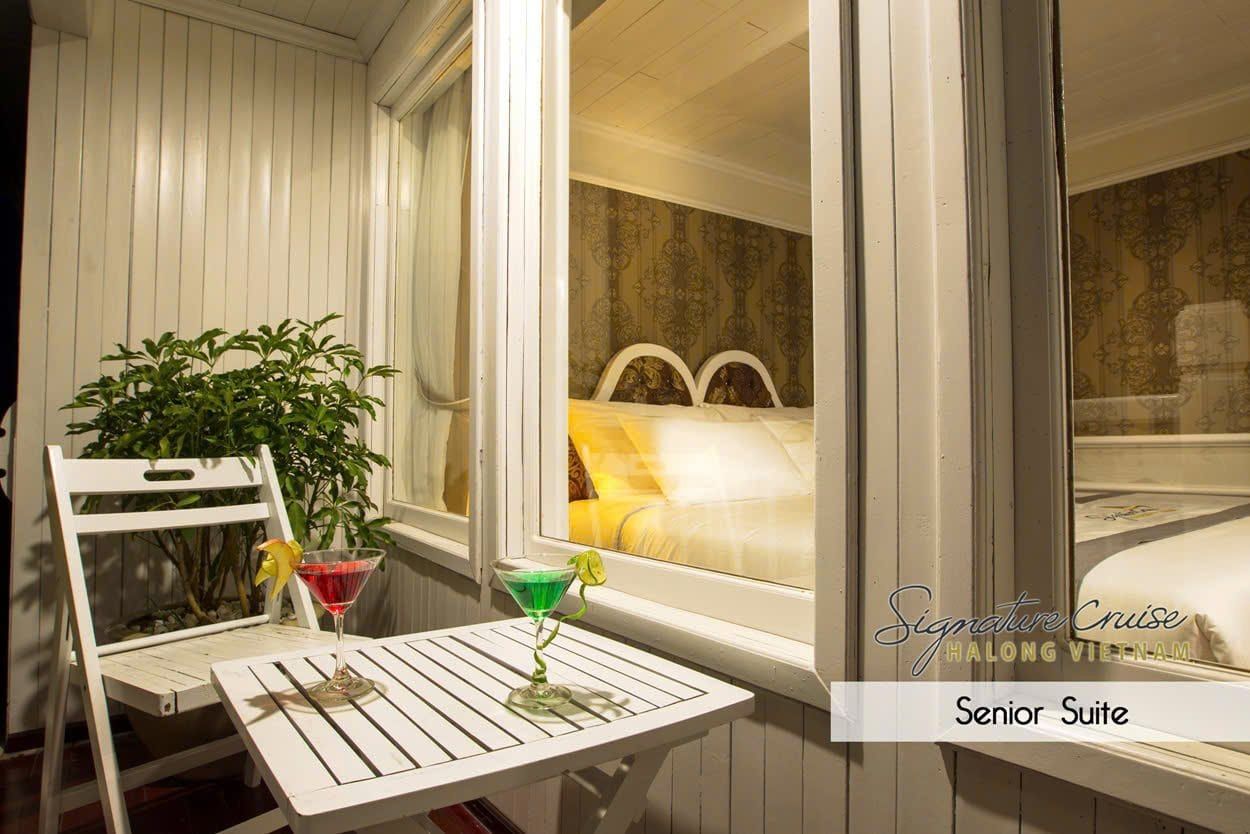 The private sun lounge of a Senior Suite, table set with a drink