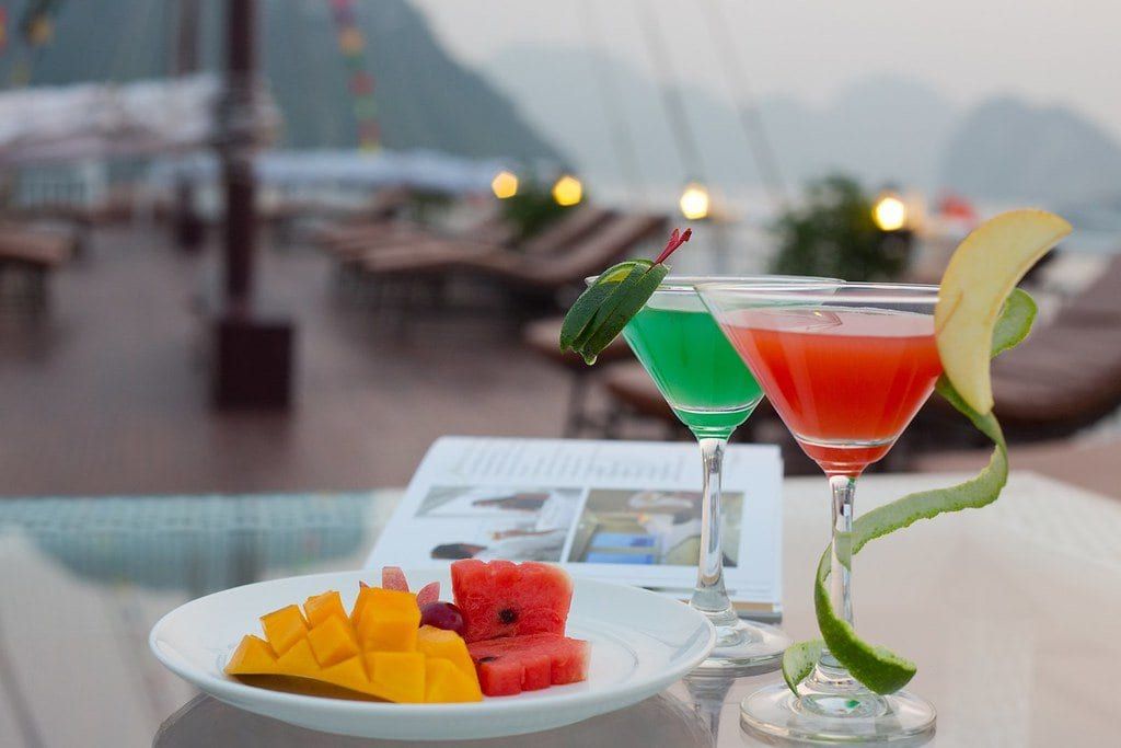 Cocktails and a fruit plate on the Signature sundeck