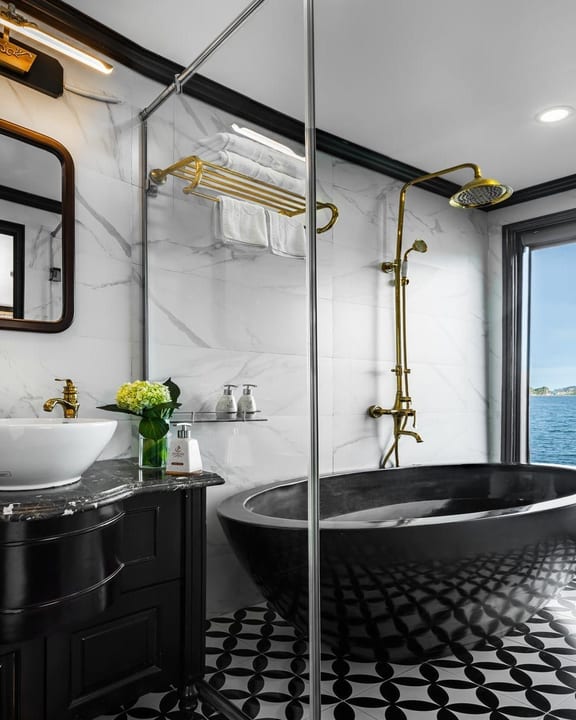 A freestanding black bath against the window of a Premium cabin