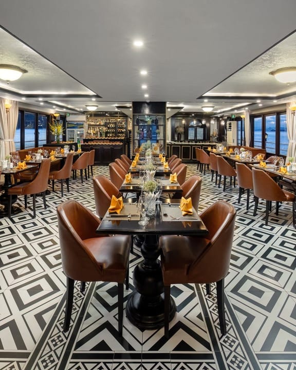 The Athena Royal restaurant laid for dinner, bay windows down both sides