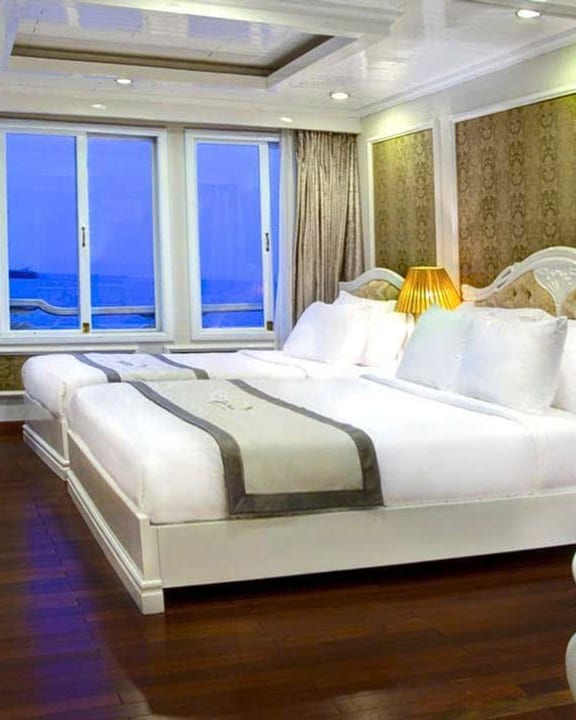 A Signature Halong suite at blue hour, the bay through the window